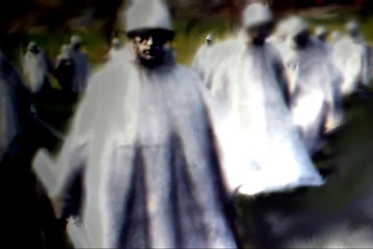 A ghostly image of GIs emerges from the Korean War Memorial in Washington.
