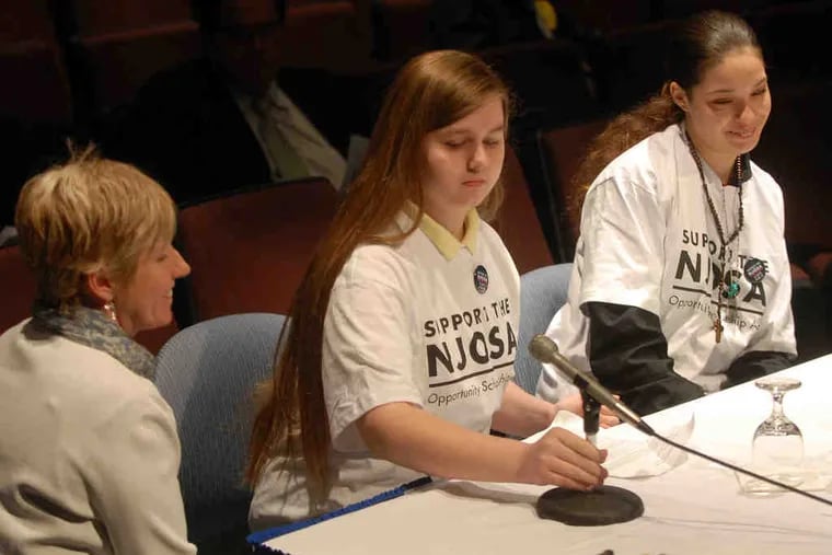Rachel Barton takes the microphone at the hearing, joined by fellow student Glenda Rodriguez and Christine Healey, an organizer from the &quot;We Can Do Better&quot; group.