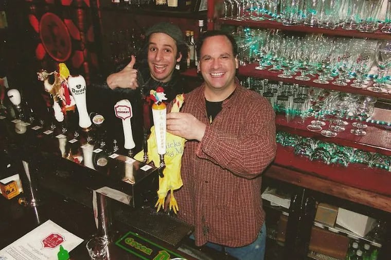 Owner Michael Naessens (right) with an unidentified employee at Eulogy Belgian Tavern in this undated photo from Eulogy's Facebook page.