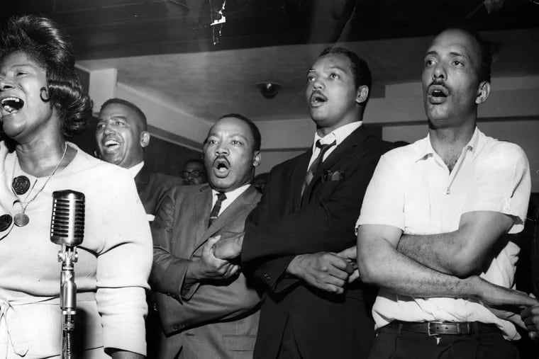Mahalia Jackson, left, sings "We Shall Overcome" with civil rights leaders the Rev. Martin Luther King, third left, Jesse Jackson, second from right, and Albert Raby, right, on Aug. 4, 1966.