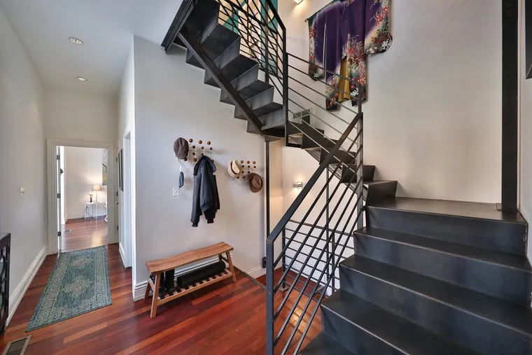 The house is built around a four-story industrial “floating staircase.”
