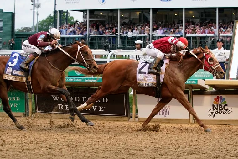 Rich Strike (21), with Sonny Leon aboard, beats Epicenter (3), with Joel Rosario aboard, at the finish line to win the 148th running of the Kentucky Derby horse race at Churchill Downs.