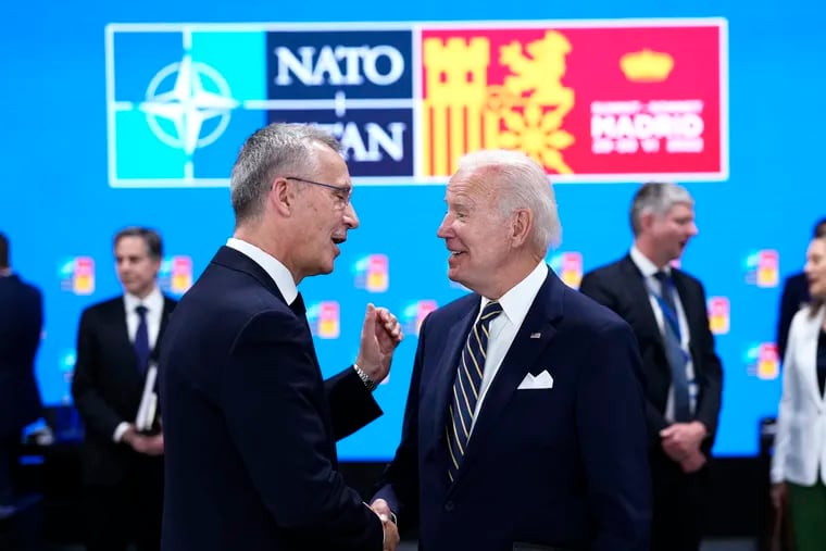 NATO Secretary General Jens Stoltenberg (left) speaks with U.S. President Joe Biden during a round table meeting at a NATO summit in Madrid on Thursday.