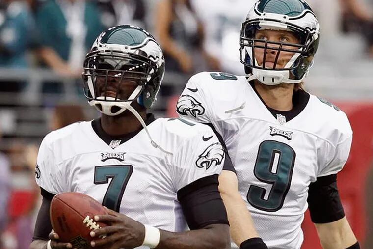 Michael Vick (7) and Nick Foles (9) warm up prior to an NFL football game against the Arizona Cardinals Sunday, Sept. 23, 2012, in Glendale, Ariz. (Ross D. Franklin/AP file)