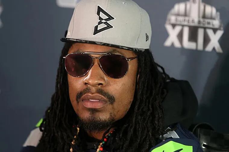 Seattle Seahawks running back Marshawn Lynch with reporters during the Seattle Seahawks press conference at Arizona Grand. (Peter Casey/USA Today)