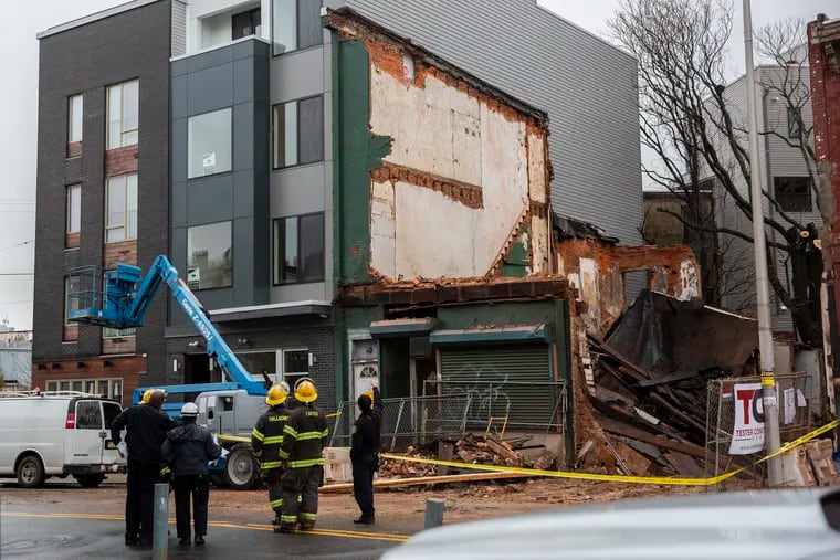 Firefighters, police, and rescue crews are on the scene of a building collapse at Ridge Avenue and Vineyard Street in North Philadelphia on Friday, Dec. 21, 2018.