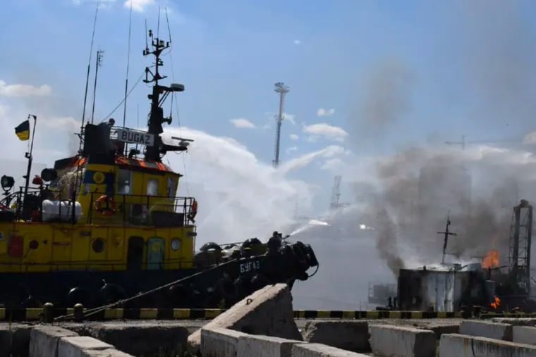 Firefighters put out a fire in the port after a Russian missiles attack in Odesa, Ukraine, in June 5. Russian missiles struck Ukraine's Black Sea port of Odesa just hours after Moscow and Kyiv signed deals to allow the resumption of grain exports.