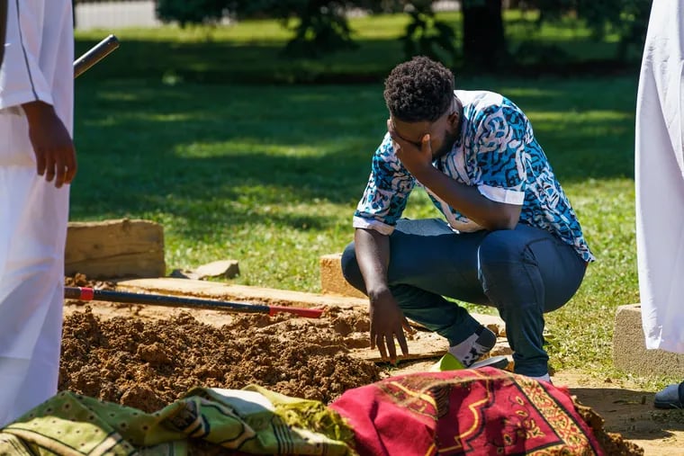 Simeon Koroma grieves for his friend Isiaka Meite during the funeral service at Friends South Western Burial Ground, in Upper Darby where friends, family, and community members gathered, June 21, 2019. Simeon said that Isiaka Meite was his best friend, they were close in high school and stayed close playing in a recreational soccer league. Meite was killed when a gunman opened fire on a graduation party he was attending, at Paschall Playground in Southwest Philadelphia.