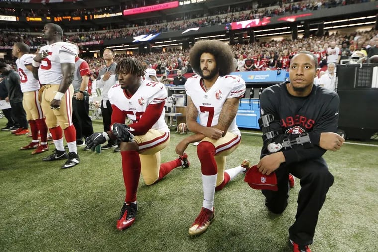 Former San Francisco 49ers quarterback Colin Kaepernick (7) taking a knee during the playing of the national anthem last season