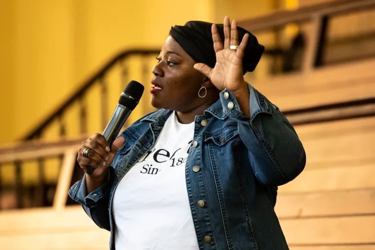 Reverend Naomi Washington-Leapheart, director for the Mayor's Commission on faith-based and interfaith affairs, speaks during Rise Up for Reparations.