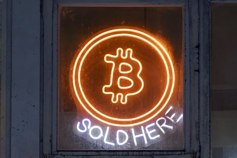 An illuminated logo for cryptocurrency Bitcoin is seen in Hong Kong in March.