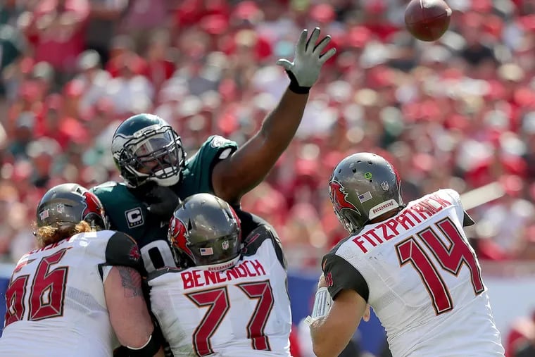 Eagles' Fletcher Cox tries to block a pass by the Buccaneers' Ryan Fitzpatrick, right, in the 4th quarter. Philadelphia Eagles lose 27-21 to the Tampa Bay Buccaneers in Tampa, Fl on September 16, 2018. DAVID MAIALETTI / Staff Photographer