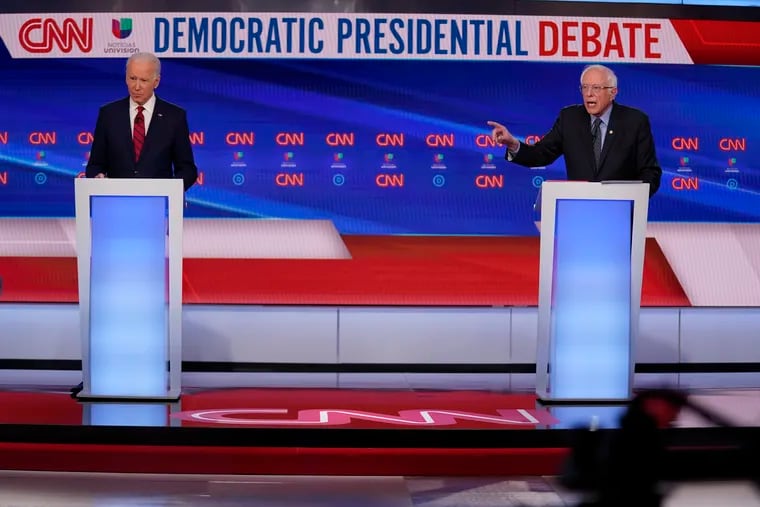 Former Vice President Joe Biden, left, and Sen. Bernie Sanders, I-Vt., right, participate in a Democratic presidential primary debate at CNN Studios in Washington, Sunday, March 15, 2020.