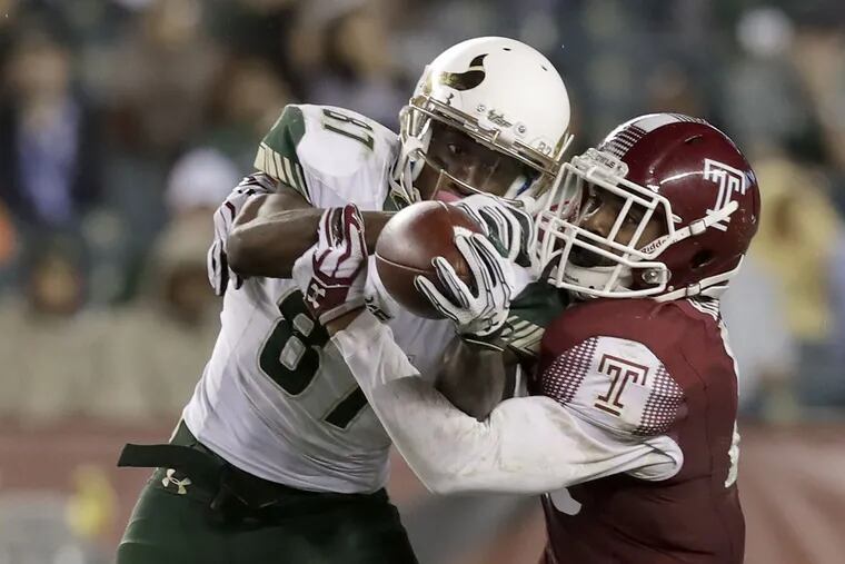 USF's Rodney Adams catches the football against Temple's Delvon Randall on Oct. 21.