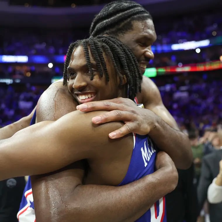 Philadelphia 76ers guard Tyrese Maxey hugs teammate Joel Embiid after their NBA play-in tournament win against the Miami Heat at the Wells Fargo Center in Philadelphia on Wednesday, April 17, 2024.