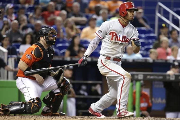 Phillies Nick Williams, right, watches after driving in the go-ahead run and an insurance run in the twelfth inning of the Phillies 3-1 win over the Marlins.