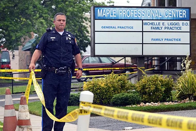 A police officer at the site of the apparent murder-suicide shooting of Pennsauken doctor Michelle Liggio Tuesday, June 18, 2013. Christopher Liggio allegedly shot and killed his wife before turning the gun on himself. TOM GRALISH / Staff Photographer