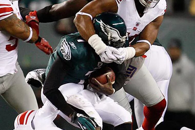 Michael Vick was sacked three times in the Eagles' win over the Giants. (David Maialetti/Staff Photographer)