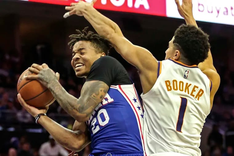 Sixers' Markelle Fultz goes up against Phoenix Suns' Devin Booker at the Wells Fargo Center Monday, November 19, 2018.  The next day, in a surprise to team, Fultz said he will see a shoulder specialist in New York and will not take part in team practices or games until he has been evaluated.