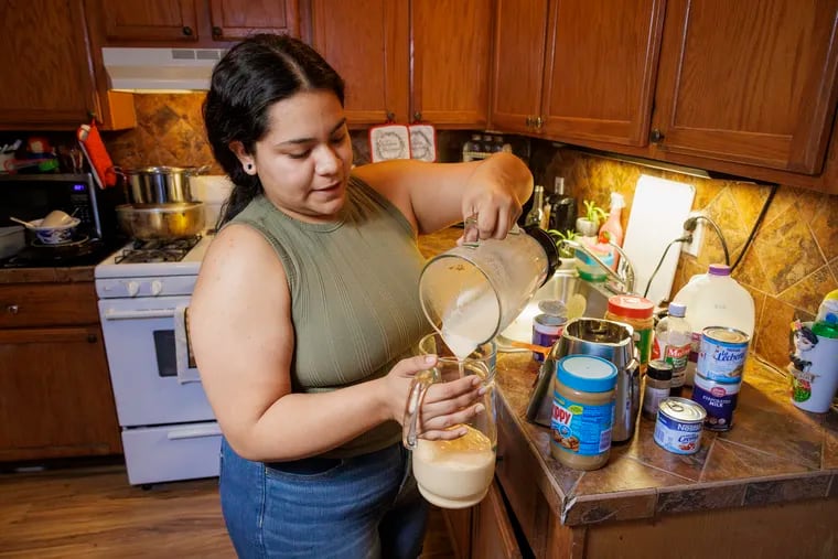 Katherine Lopez of Philadelphia demonstrates how to make Torito, a popular drink in the Veracruz region of Mexico. Photograph taken on Monday, Jan. 22, 2024. Katherine pours her mix into glass pitcher before adding rum, the final ingredient.