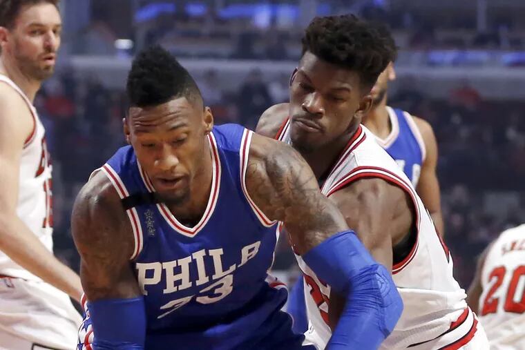 Bulls guard Jimmy Butler strips the ball from Robert Covington (left) during the first half. Chicago took control with a 26-1 run over the third and fourth quarters.
