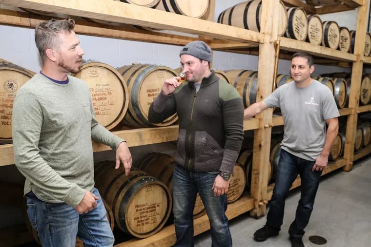 Distiller Tim Mokes (left), with owners Marat and Vlad Mamedov, at Boardroom Spirits.