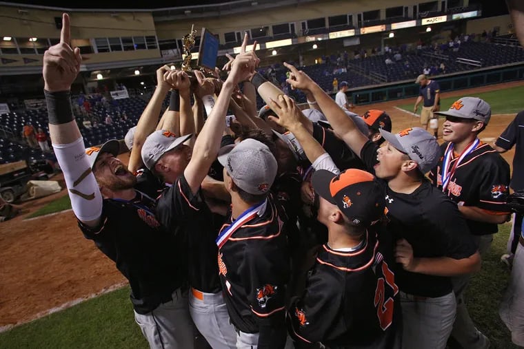 The Marple Newtown players and coaches celebrate after winning the state championship.