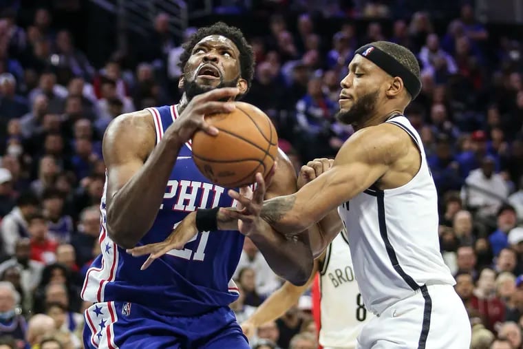 Sixers Joel Embiid gets fouled by Nets Bruce Brown during the 1st quarter at the Wells Fargo Center in Philadelphia, Thursday,  March  10, 2022.