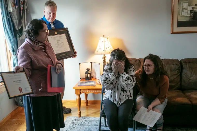 Prof. Robin Kolodny, department chair of political science at Temple, presents a diploma and other honors for Sam Collington at the Collington family home in Prospect Park, Pa. on Saturday, Feb. 19, 2022. Collington was fatally shot after the Thanksgiving break near Temple’s campus during a robbery/carjacking.