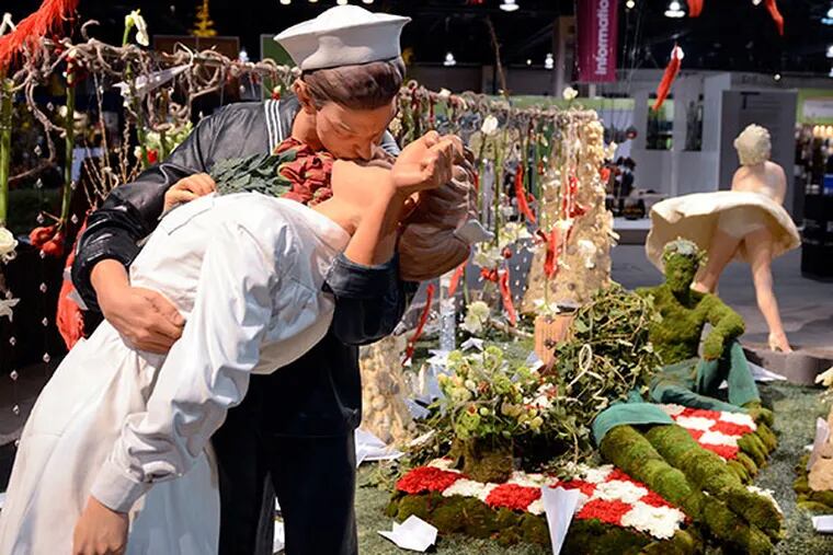 A life-size statue inspired by the Alfred Eisenstaedt Times Square on V-J Day photograph is part of the Michael Bruce Florist display at the Philadelphia Flower Show on Friday, February 28, 2014 at the Pennsylvania Convention Center. ( TOM GRALISH / Staff Photographer )