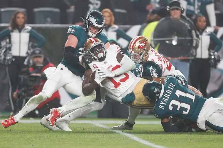 Eagles safety Reed Blankenship and safety Kevin Byard go after San Francisco 49ers wide receiver Deebo Samuel with teammate running back Christian McCaffrey in the second quarter on Sunday, December 3, 2023 in Philadelphia.