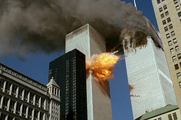 United Airlines Flight 175 collides into the south tower of the World Trade Center as smoke billows from the north tower.