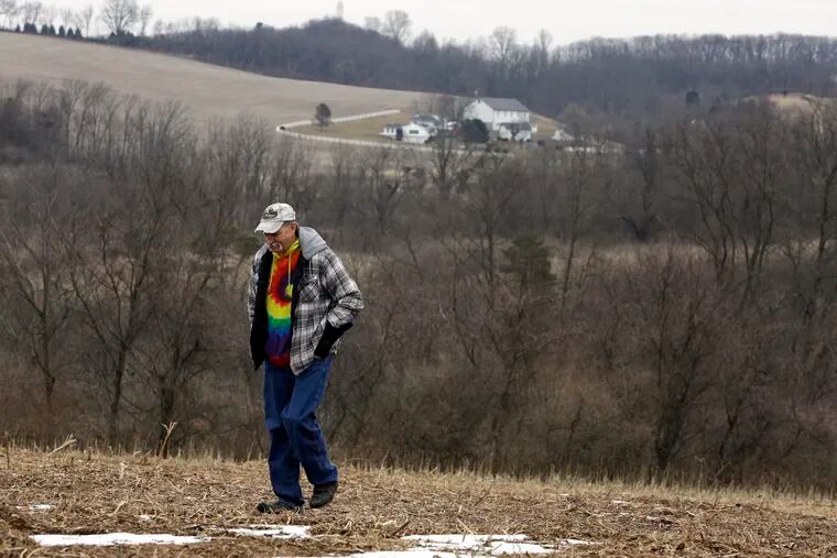 Mike Carpenter, uncle of Greg Longenecker, walks the Berks County field where Longenecker was killed by a Pennsylvania Game Commission bulldozer. Carpenter's lawsuit accuses Pennsylvania State Police of gross recklessness for using a bulldozer to chase and kill Longenecker, who had fled after being caught growing marijuana on public land.