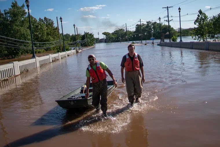 U.S. Geological Survey workers push a boat as they look for residents on a street flooded as a result of the remnants of Tropical Storm Ida in Somerville, N.J., in September. State officials said the flooding is an example of why big water infrastructure projects are needed.