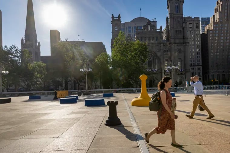 Pedestrians cross the plaza on the east side of the Municipal Services Building located at N. Broad and JFK Blvd. in Philadelphia on May 31, 2022.