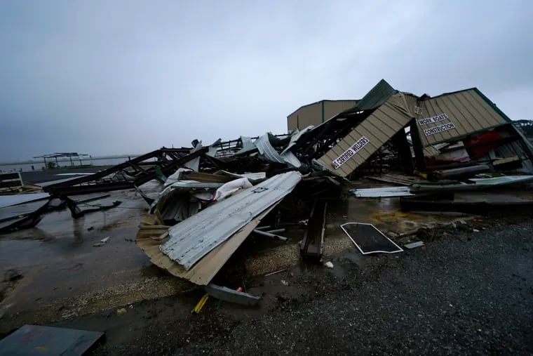 A Louisiana business destroyed by Hurricane Laura lies in pieces on Thursday as the region awaited Delta's arrival.