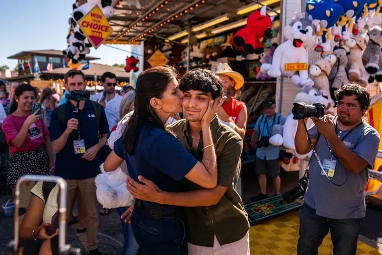 Former South Carolina governor Nikki Haley kisses her son Nalin at the Iowa State Fair Grounds on Aug. 12.