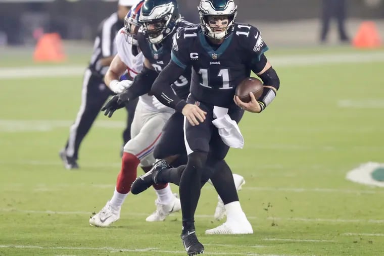 Eagles quarterback Carson Wentz takes off running in Thursday's game against the Giants.