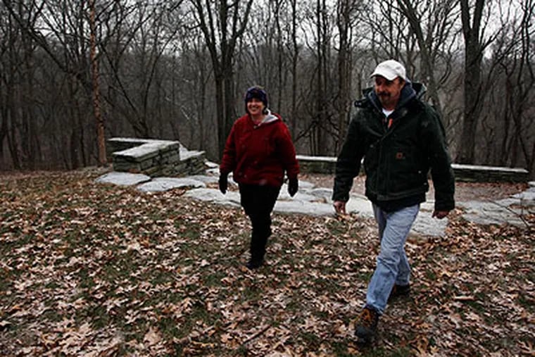 Anne Bower, vice president of the board of trustees of the Schuylkill Center for Enviromental Education, and Sean Duffy, director of land and facility management at the center, walk grounds that are part of the land that has recently been conserved. (Laurence Kesterson / Staff Photographer)