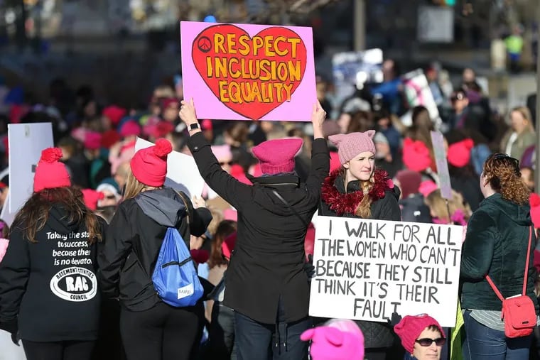 Kristyn Stickley, 22, of West Chester, PA, at right, holds a sign during the Women's March on the Ben Franklin Parkway in Philadelphia, PA on Jan. 20, 2018.