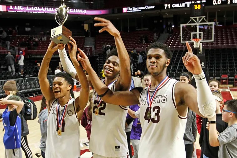 Abington seniors (from left) Darious Brown, Lucas Monroe and Eric Dixon celebrate after the Ghosts won the District 1 Class 6A boys basketball championship Saturday, March 2, 2019, at the Liacouras Center. Abington defeated Coatesville in overtime in the final, 74-71.