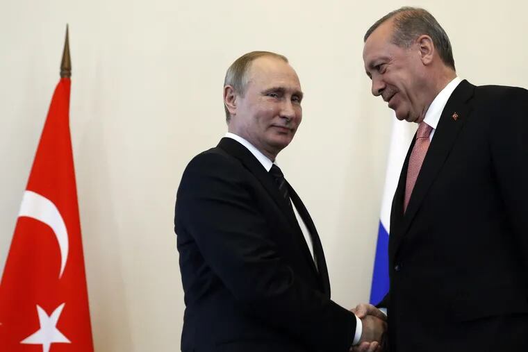 Russian President Vladimir Putin, left, welcomes Turkish President Recep Tayyip Erdogan in the Konstantin palace outside St.Petersburg, Russia, on Tuesday, Aug. 9, 2016.