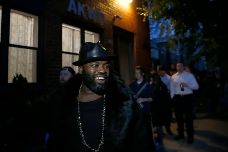 Tariq "Black Thought" Trotter of The Roots smiles after passing out water bottles to people waiting to vote at the Northern Liberties Community Center on Election Day in Philadelphia, PA on November 8, 2016.  DAVID MAIALETTI / Staff Photographer
