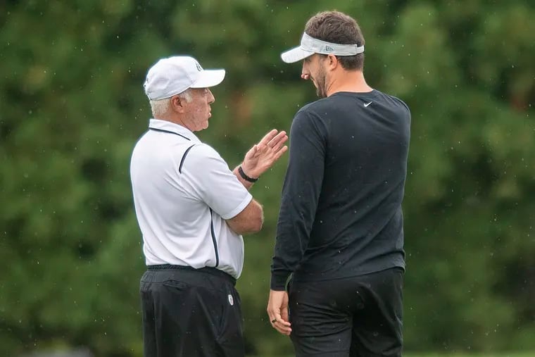 Eagles owner Jeffrey Lurie (left) talking to head coach Nick Sirianni during a September practice.
