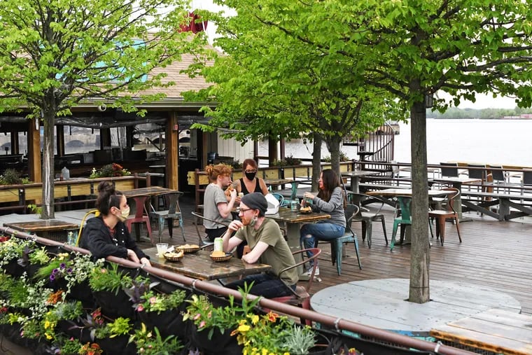Staffers at Morgan's Pier test a new seating arrangement with added space for social distancing as the massive beer garden prepares for the possibility of outdoor dining being allowed if the state relaxes its restrictions on restaurants.