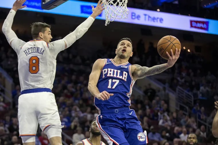 JJ Redick of the Sixers goes up for a basket against Mario Hezonja of the Knicks during the first half.