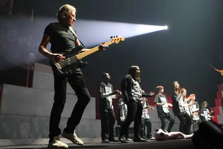 Roger Waters, co-founder and songwriter for Pink Floyd performs "Another Brick in the Wall" during his concert at the Well Fargo Center Monday night. (Michael Bryant / Staff Photographer)