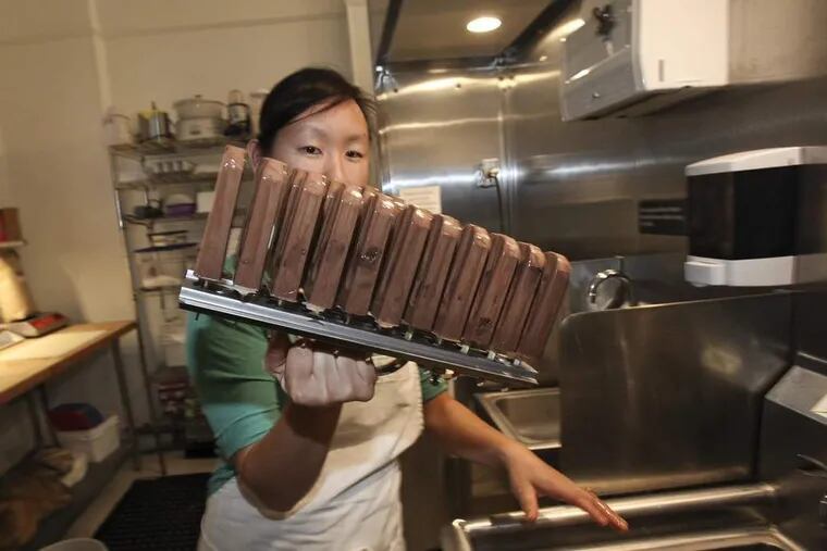 Lil' Pop Shop owner Jeanne Chang with chocolate with salted caramel brownie.   ( STEVEN M. FALK / Staff Photographer )
