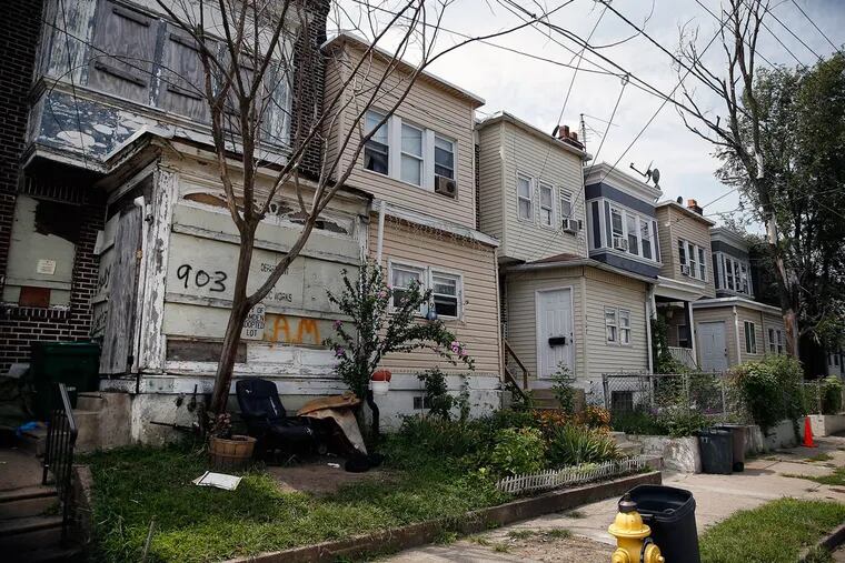 The property (left) at 903 N. 19th St. is among almost 600 in Camden that have been targeted for
demolition.