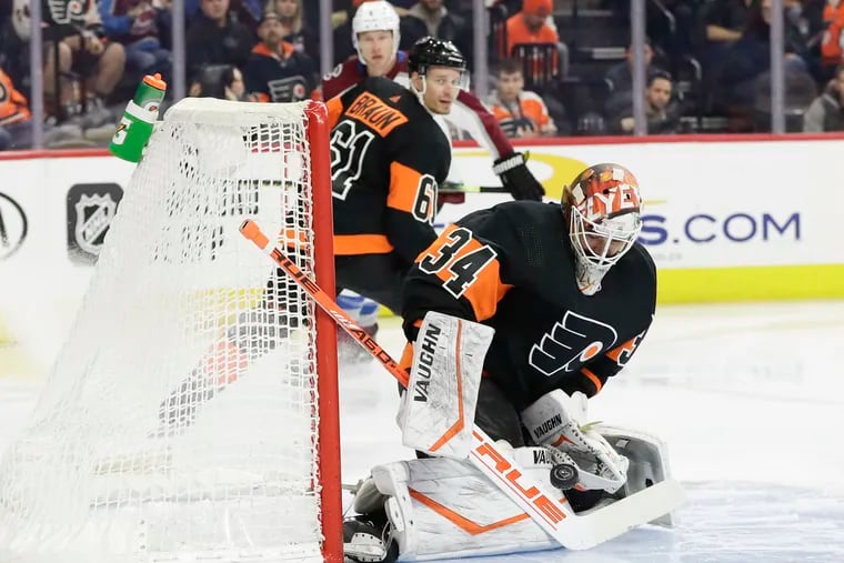 Flyers goaltender Alex Lyon stopping the puck against the Colorado Avalanche on Feb. 1, 2020, the date of his last NHL win. He will face the Rangers on Friday in New York.